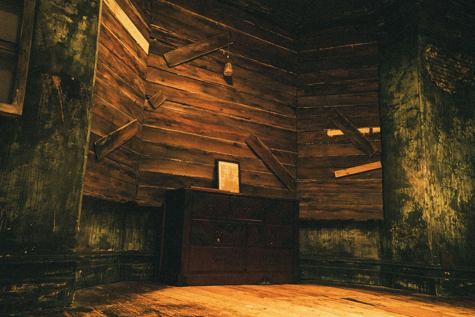 A boarded-up room with timber planks nailed across the walls in The Haunting