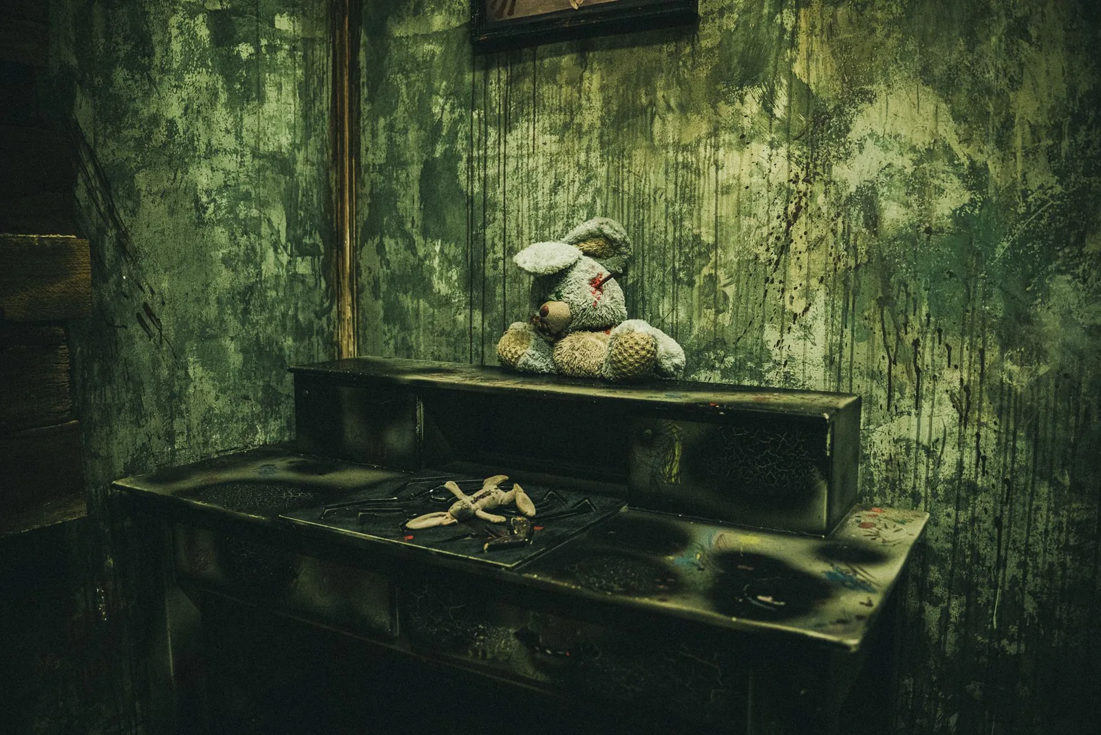 A stitched toy rabbit slumped on a mould-stained desk in The Haunting