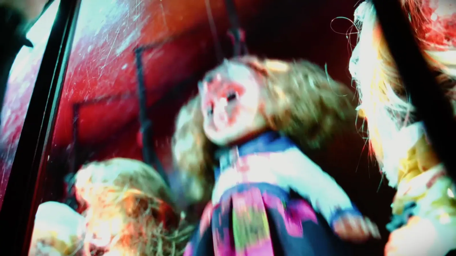 Ragged dolls pressed behind glass in The Haunting